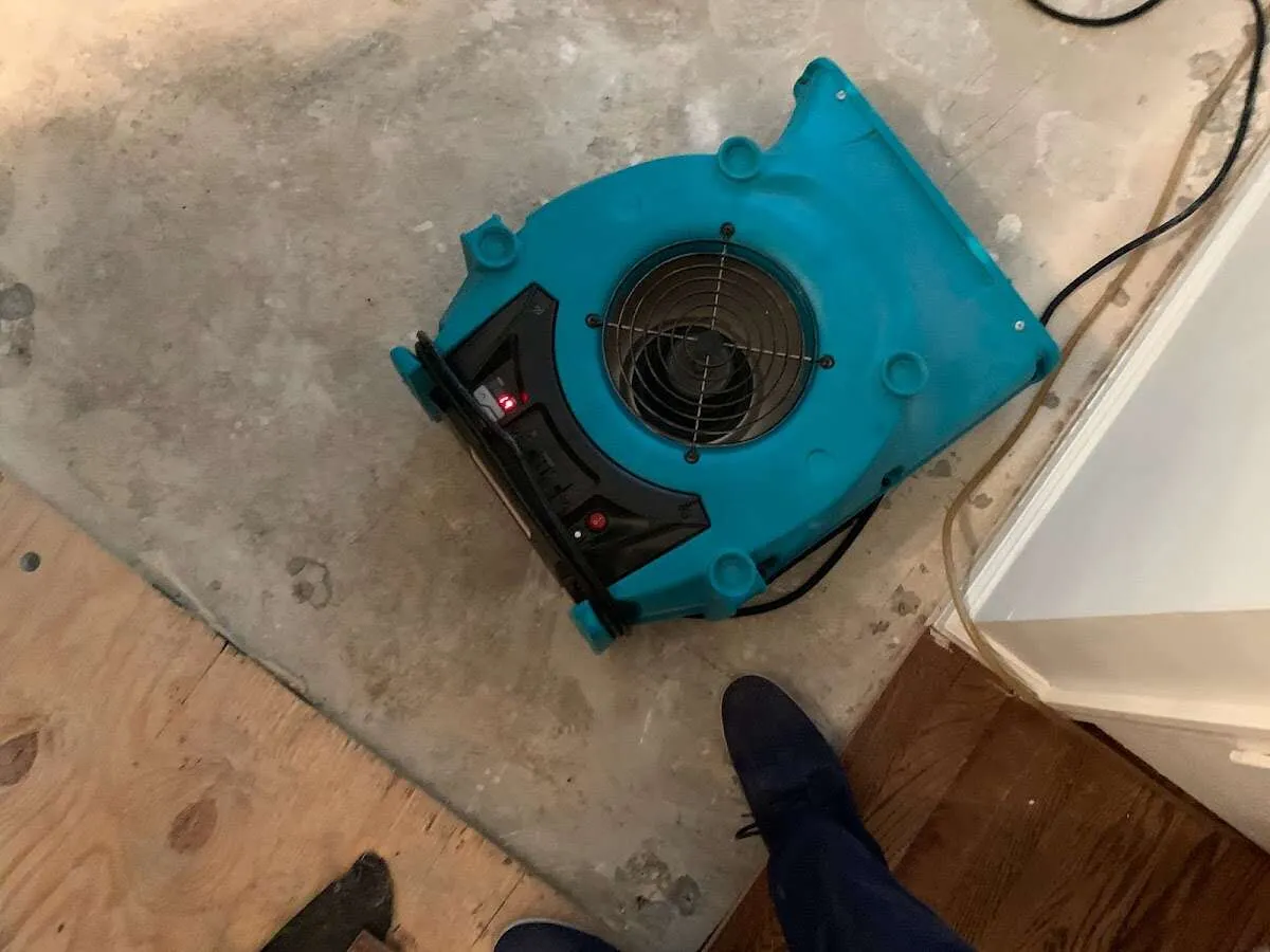 Air mover drying subfloor during Commercial Water Damage Restoration in Warrenton
